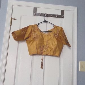 Brand new gold saree blouse with zari thread embroidery and dori.